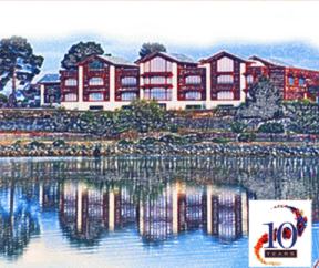 A sketch shows the library with its banks of windows above, among trees, and reflected in the harbou