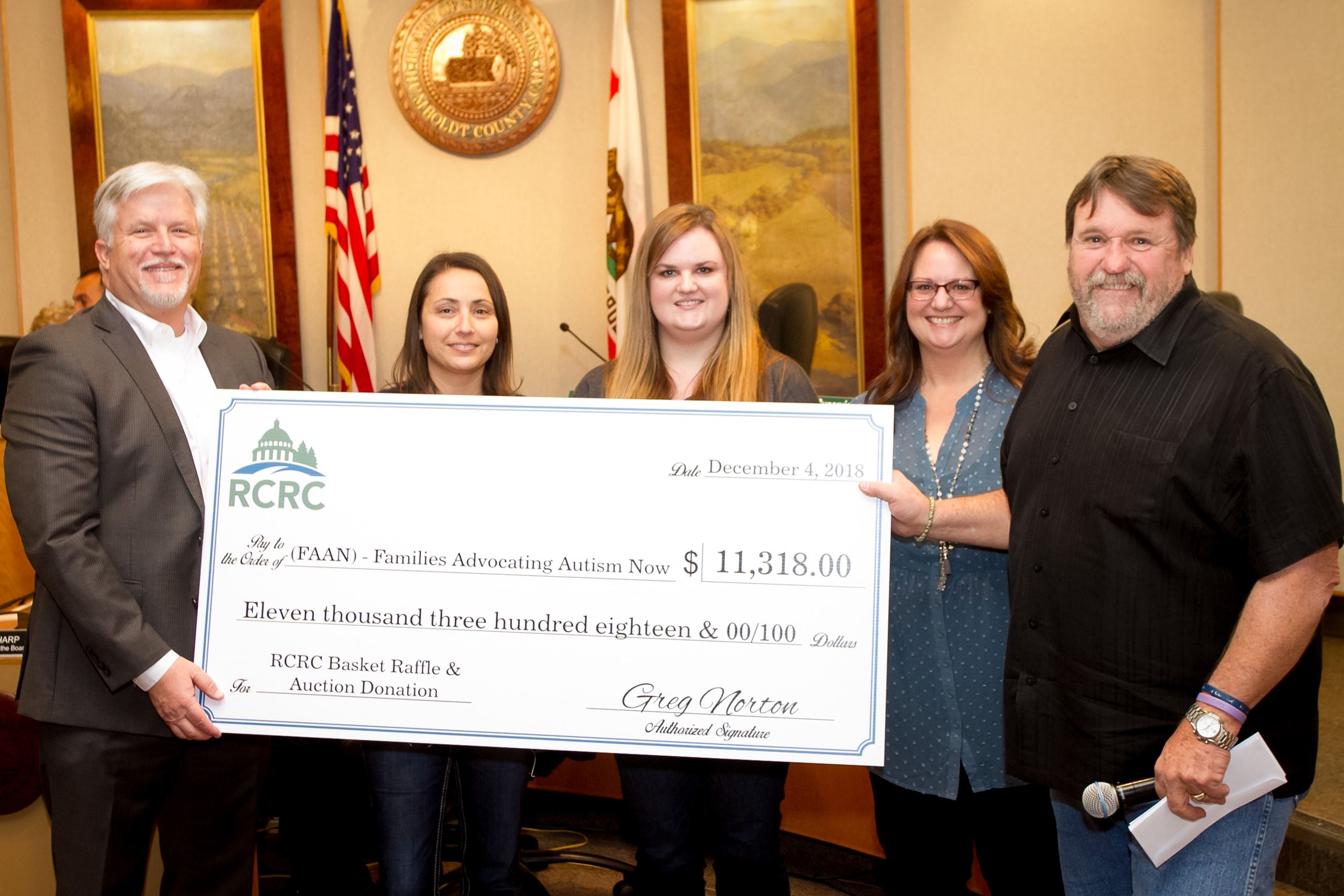 Supervisor Bohn presenting members of Families Advocating Autism Now (FAAN) with a check from RCRC f