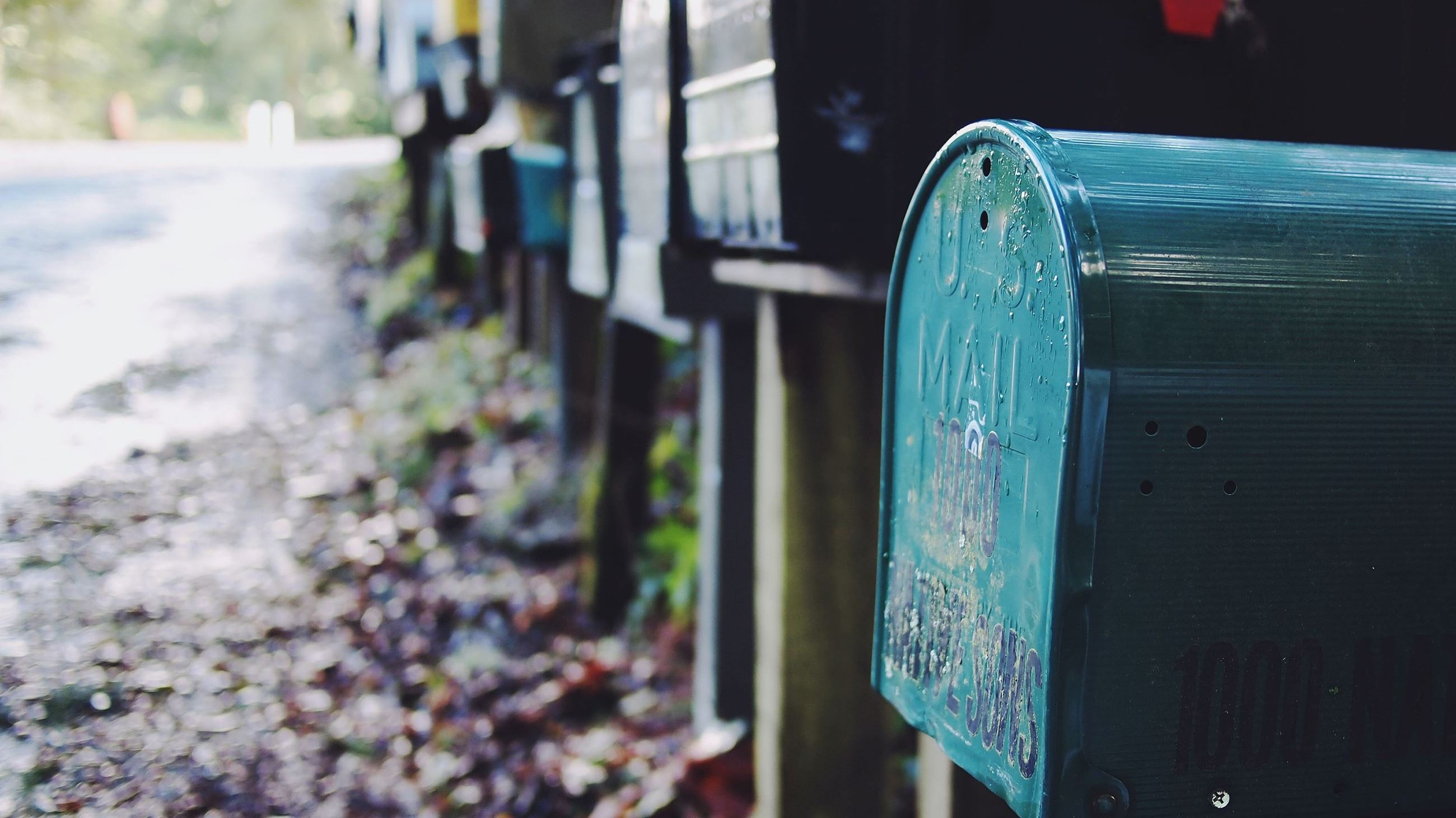 Mailboxes lined up on the side of a road