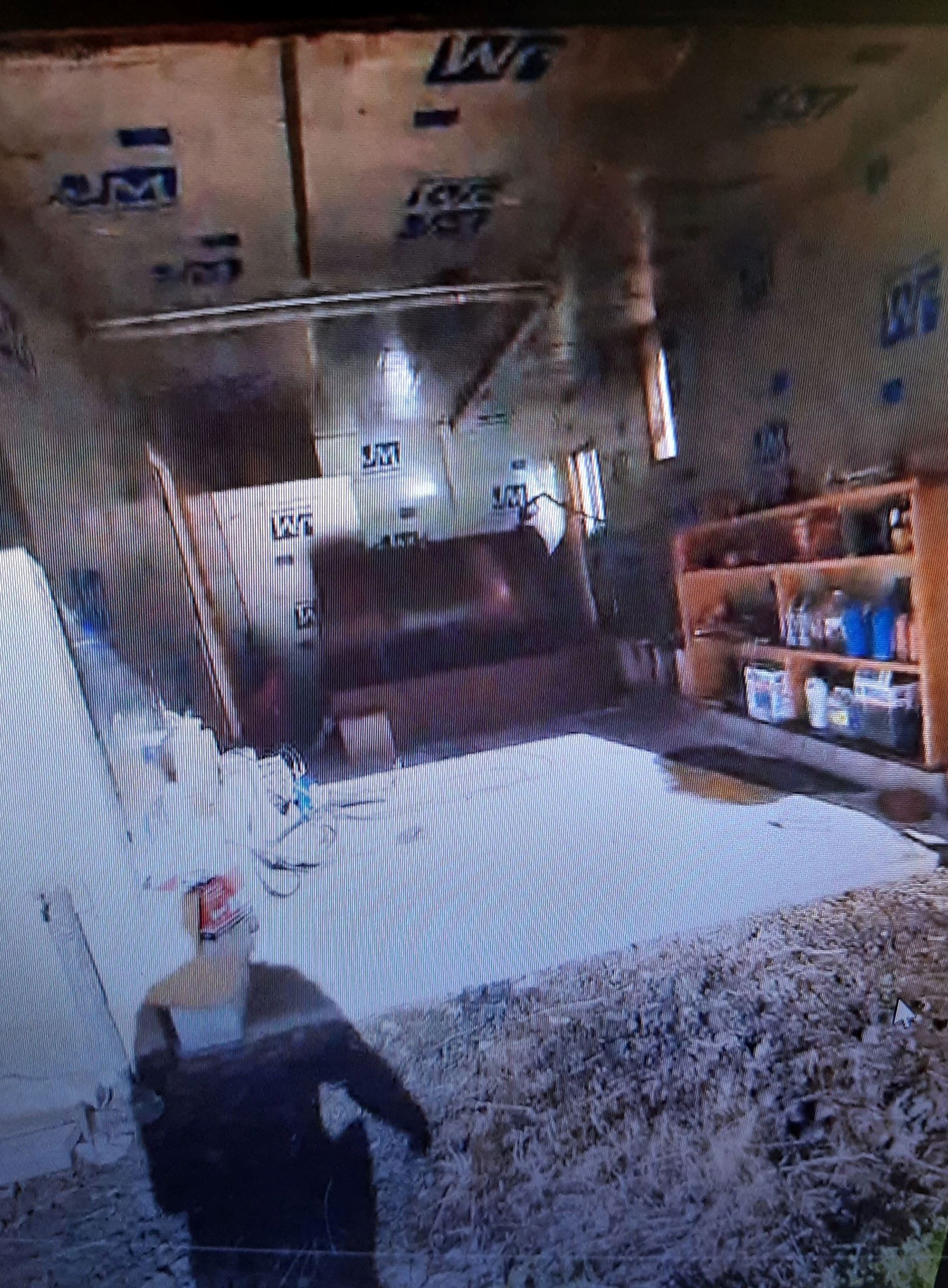 Oil spill in dirt in front of garage