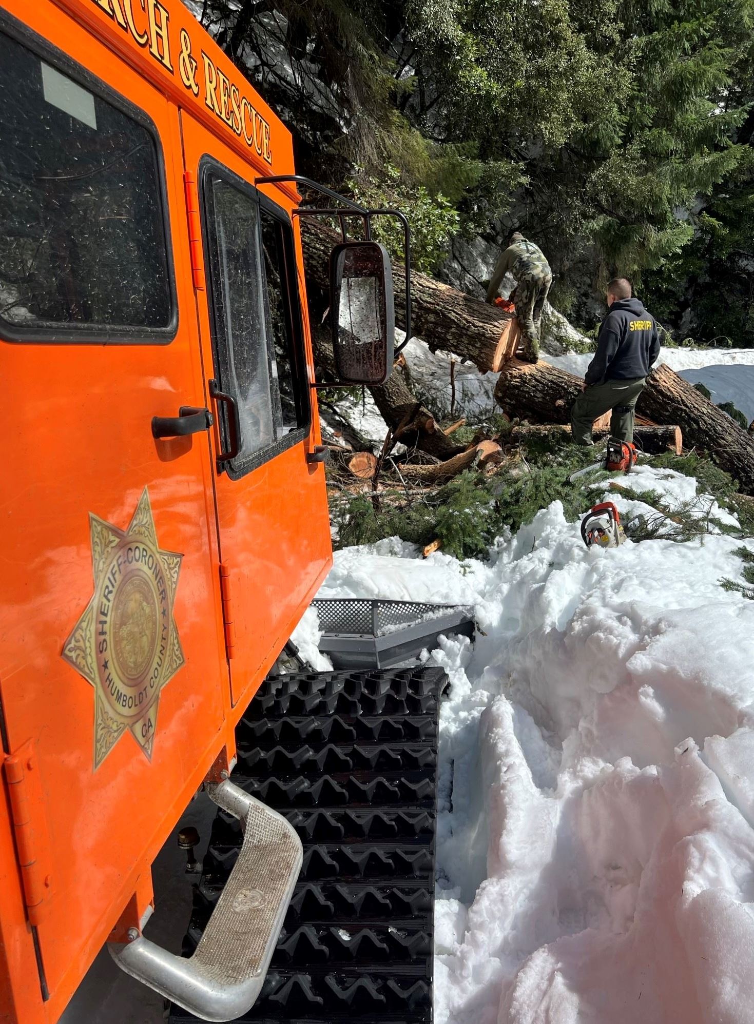 Sheriff's SnoCat parked as deputies clear a downed tree