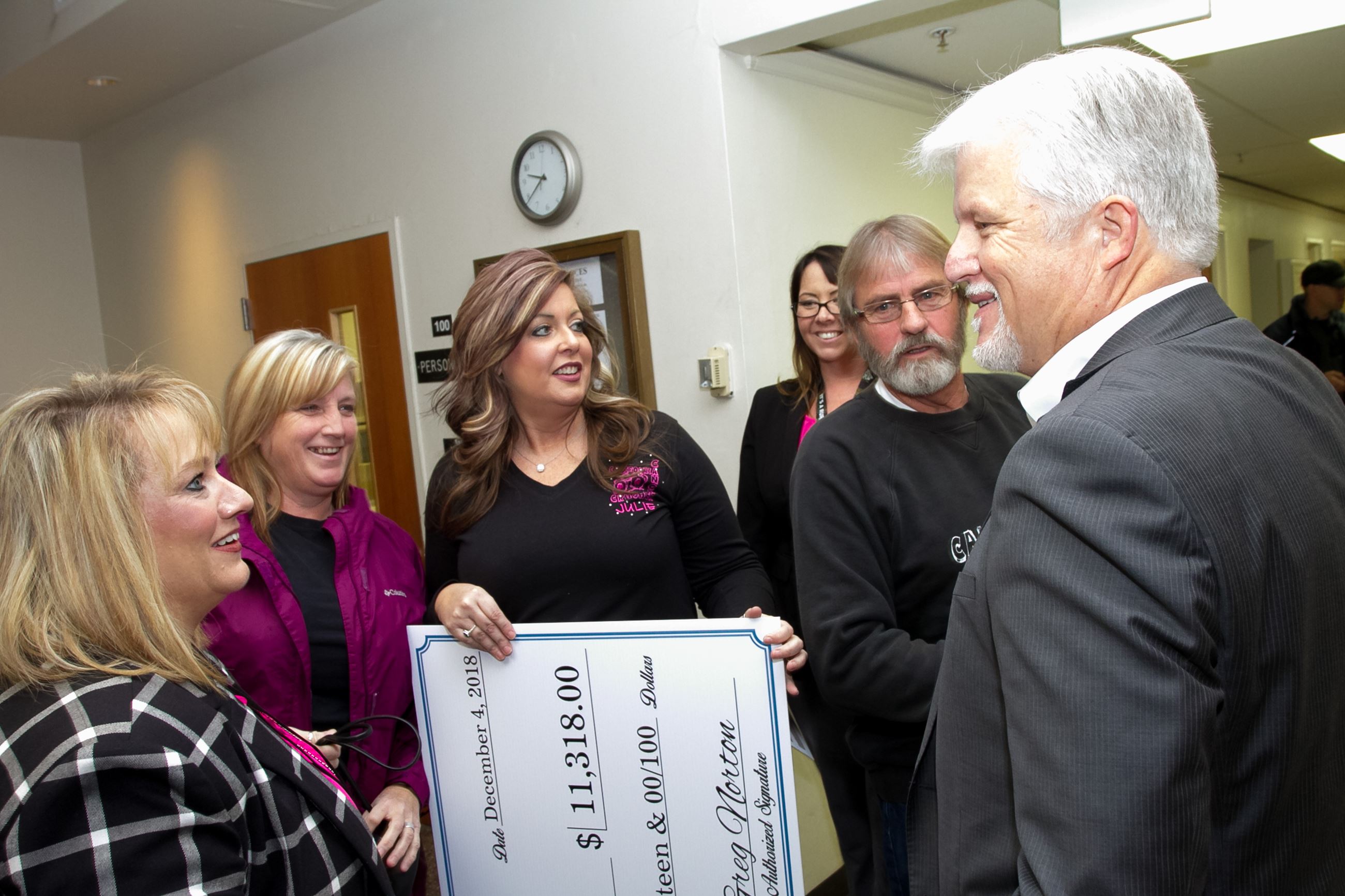 RCRC Chief Executive Officer Greg Norton, right, talks with members of the Cancer Crushers charity a