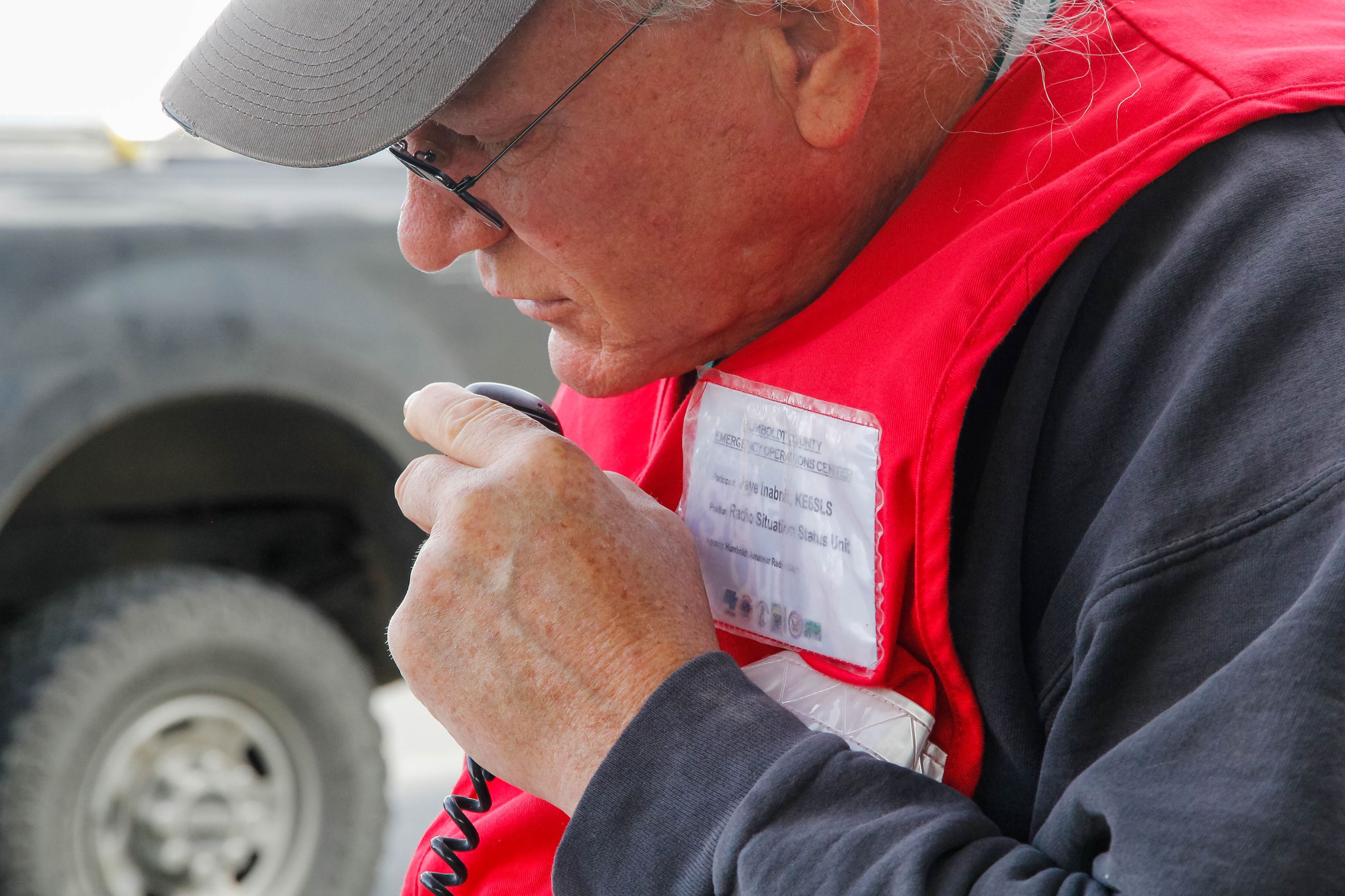 A man talks into a portable radio